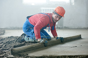 worker spreading wet conrete